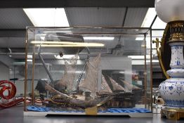 A vintage white metal filigree sailing ship model, presented inside a glass case, unmarked, 53cm x