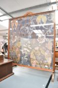 A large early 20th-century Chinese-style embroidered fire screen, fitted behind glass within a