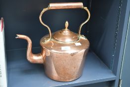 A large late 19th to early 20th-century copper fireside kettle, featuring an acorn-shaped finial,