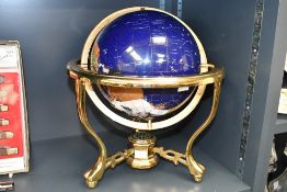 A vintage semi-precious stone tabletop World Globe, featuring a blue stone ocean and inlaid stones