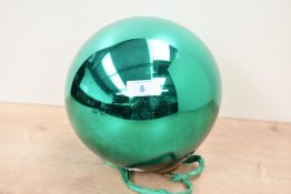 A large late 19th-century green Mercury glass witches ball, with a decorated brass finial and