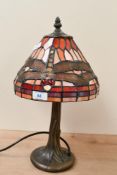 A small contemporary Tiffany-style dragonfly table lamp, featuring a leaded orange, red and yellow