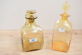 Two 20th-century Harry Powell for Whitefriars-style amber 'Roman' glass decanters, of square-form