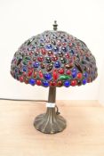 A late 20th-century Tiffany-style table lamp, featuring a domed shade of red, blue and green