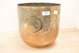 A 20th-century Balinese-style brass jardinière, featuring etched floral, foliate and figural