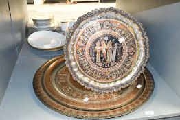 Four late 20th-century Middle Eastern-style metal chargers, to feature foliate, floral and Ancient