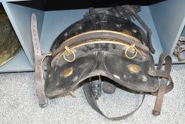 A large late 19th to early 20th-century leather work horse saddle/harness, featuring brass