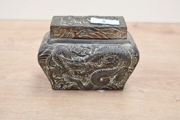 A 20th-century Oriental-style metal repoussé tea caddy, featuring a scrolled dragon motif