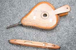 An early 20th-century wooden fireplace bellows; sold with a vintage wood weaving loom boat