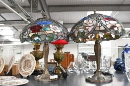 Two late 20th-century Tiffany-style table lamps, featuring a colourful domed shade of red, blue