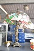 A contemporary Tiffany-style dragonfly table lamp, featuring a colourful shade of repeating