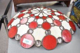 A late 20th-century Tiffany-style ceiling lamp, featuring red and cream detailing upon hanging