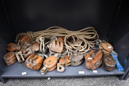 Of maritime interest, a large selection of 20th-century wood and iron block and tackle pulleys, of