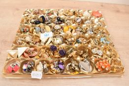 A large assortment of costume clip-on earrings, including large statement pieces, beaded pieces