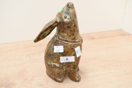 A vintage Japanese cast iron 'moon-gazing' rabbit, featuring a green verdigris patina and a sweetly