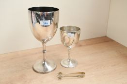 Two early 20th-century white metal goblets, to feature a smaller example with etched floral and swag
