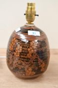 A mid to late 20th-century studio pottery lamp base, featuring scrolled floral detailing upon a