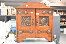 An early 20th-century Shapland and Petter of Barnstaple Arts and Crafts oak wall-mounted smoking