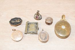 An assortment of yellow metal jewellery, including a gold plated locket having decorative scroll