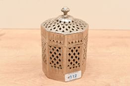 An Eastern white metal Betel nut holder, of octagonal form having a moulded finial top with