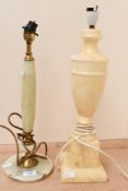 Two 20th-century hardstone lamp bases, to feature an onyx and brass example with a larger urn-formed
