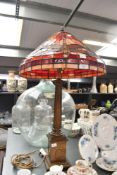 A tall 20th-century Tiffany-style table lamp, featuring a leaded orange, red and yellow shade with