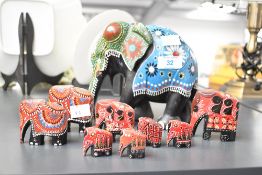 A small collection of vintage Indian-style hand painted decorative wooden elephants, all of