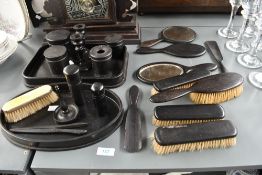 A selection of late 19th to early 20th-century ebony vanity wares, to feature a hairbrush set,