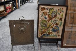 A small early 20th-century Art Nouveau brass fire screen; sold with a floral crewelwork embroidery