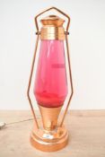 A mid 20th-century Astro Lantern, featuring a red lava bottle and copper frame, unmarked, 47cm,