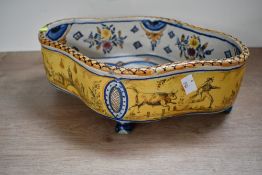 A vintage French Quimper-style faience footed jardiniere, featuring hand painted pastural scenes