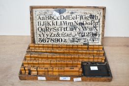 A late 19th to early 20th-century set of wooden rubber printer stamps, featuring mainly the alphabet