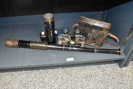A late 19th to early 20th-century metal military-style three-draw telescope, featuring two worn