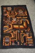 A large vintage Peruvian wool embroidered wall hanging, featuring traditional Incan God motifs and