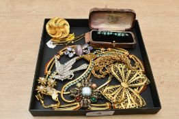 An assortment of costume jewellery and miscellaneous items, including beaded necklaces, wristwatches