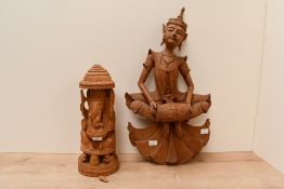 Two 20th-century hand carved decorative wooden statues, to feature a statue of the Hindu Deity