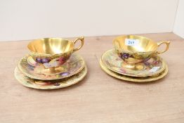 Two fine early 20th-century Aynsley 'Orchard Gold' bone china tea trio sets, featuring delicate
