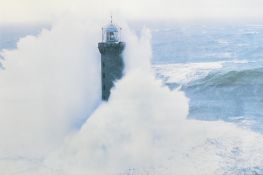A pair of 20th century photographic colour prints, depicting lighthouses in rough seas, unsigned