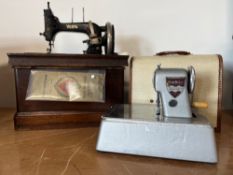 A vintage German Vesta hand-cranked boat shuttle sewing machine with original instruction manual, in
