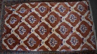 A 1970s vintage curtain in brushed velvet towelling fabric, having a terracotta ground with beige,