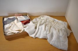 An early 20th century ivory silk christening gown and accompanying silk cloth / sash, both having