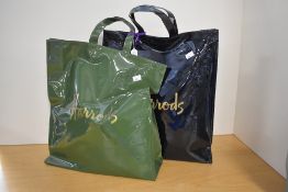 Two vintage Harrods PVC shopper tote bags, a black and a hunters green, each bearing the gold