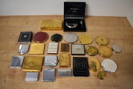 A collection of 20th century vintage art deco gilt and white metal compacts featuring a theme of