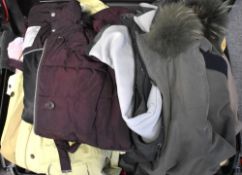 A suitcase of 1990-2000s womens coats to include butter yellow Dannimac, aubergine John Rocha