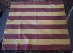 A 20th century Durham patchwork quilt with wide alternating stripes of butter yellow and burgundy