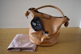 A Radley bucket handbag in light tan textured leather, has popper closure, leather cable handle with