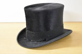 Two antique top hat boxes in brown leather with plush quilted interiors in purple in the taller
