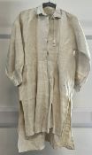 An antique night shirt in off white heavyweight linen, embroidered with cross stitch lettering at