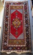 A 20th century vintage Louise De Poortere 'KARIAN' rug in 100% Pure New Wool, has central floral