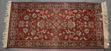 Two 20th century vintage Louise de Poortere 'kandahar' small area rugs having a red ground, all over